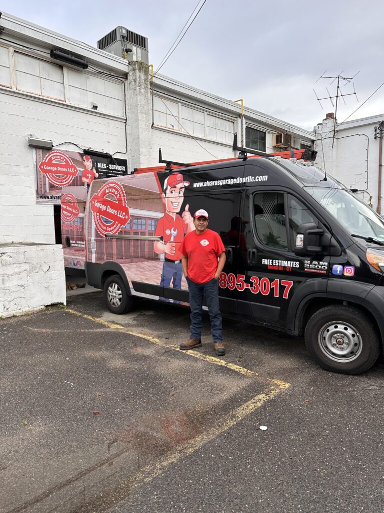 Alvaro's team member beside a branded service van at the Monroe showroom