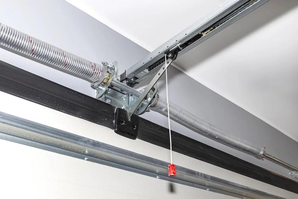Torsion springs and centre bracket above a sectional overhead door